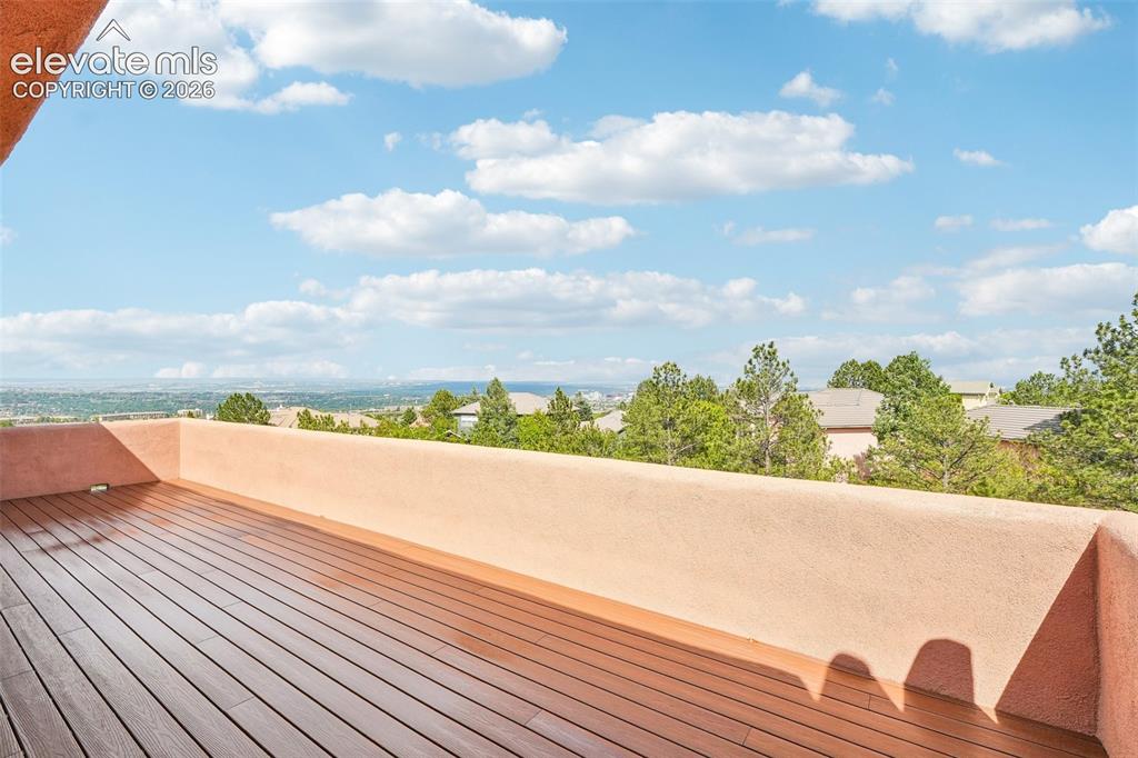 Image 28 of 50: Walk out deck off primary bedroom with views of the city and mountains!!!