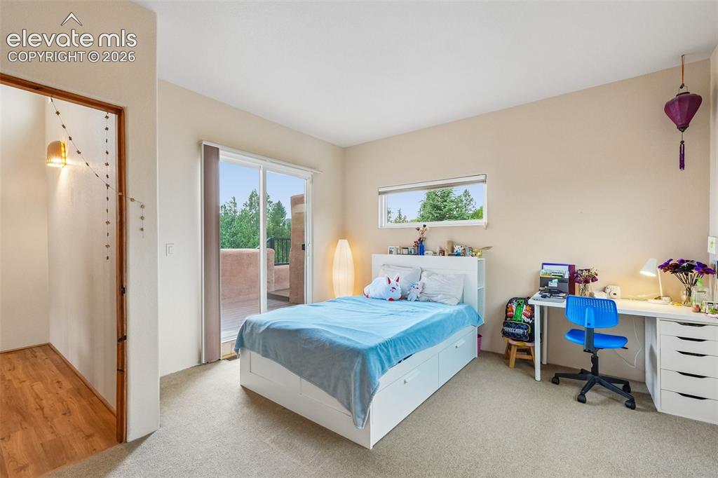 Image 29 of 50: Walk out deck off primary bedroom with views of the city and mountains!!!