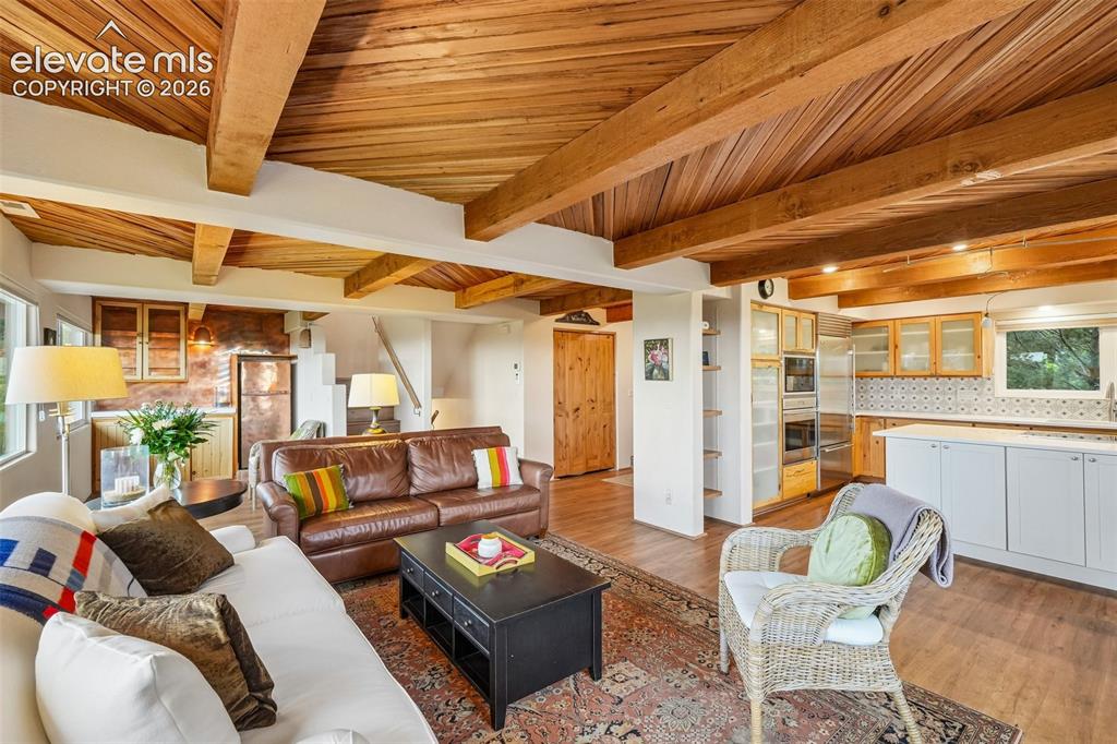 Image 3 of 50: Grand foyer with wood beamed ceilings and LVP flooring