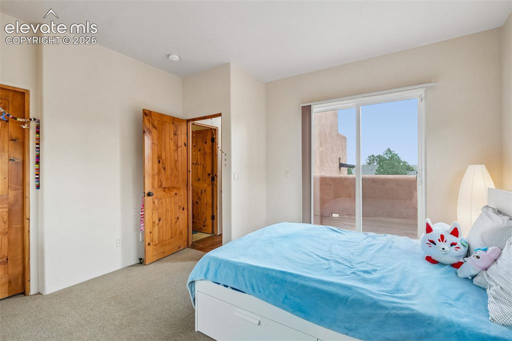 Image 30 of 50: Walk out deck off primary bedroom with views of the city and mountains!!!