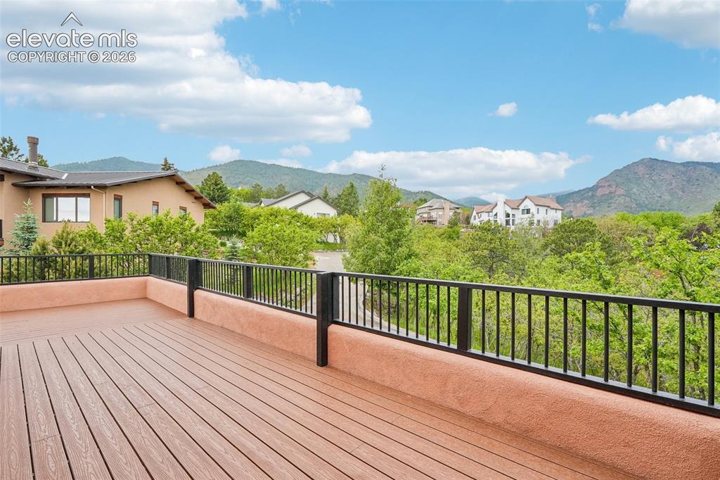 Image 34 of 50: Walk out to wrap around deck off of bedroom 2