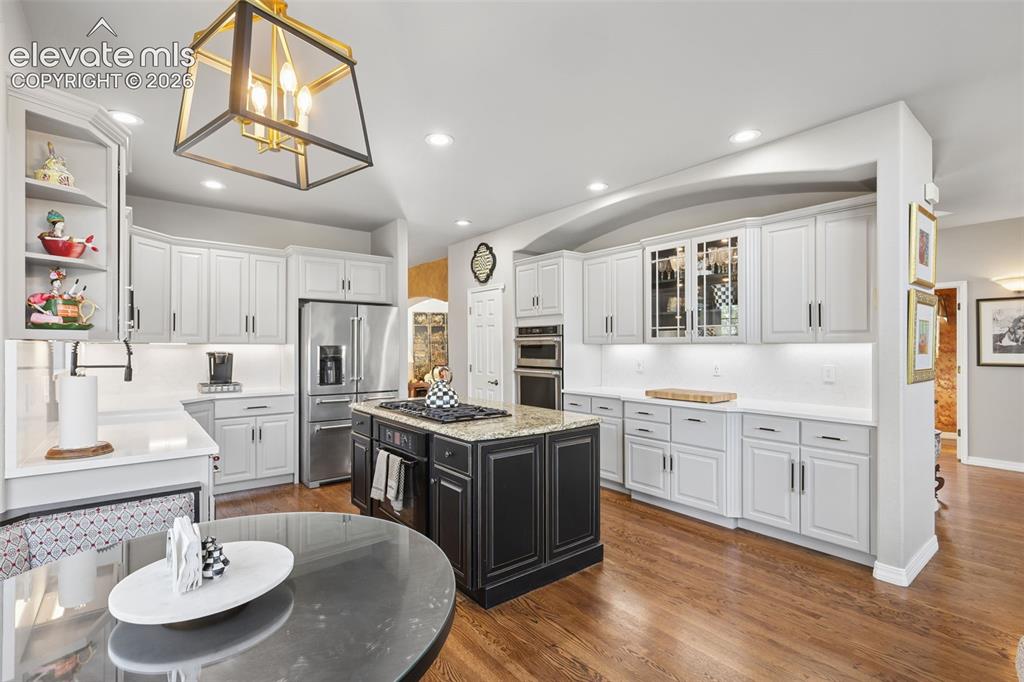 Image 15 of 50: Beautifully remodeled gourmet kitchen with granite, quartz, wood floors, is