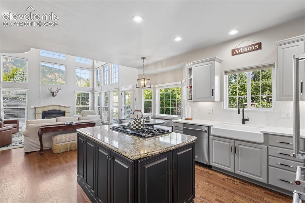Image 16 of 50: Light and bright kitchen open to family room with vaulted ceiling and breat