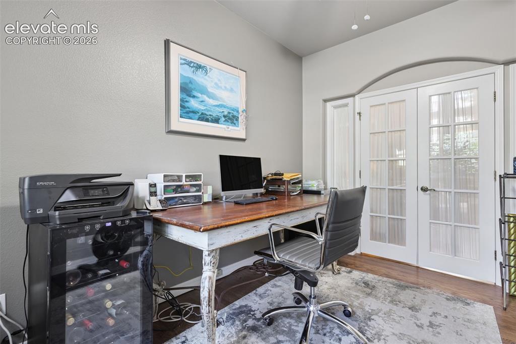 Image 25 of 50: Main level office has closet and french doors.