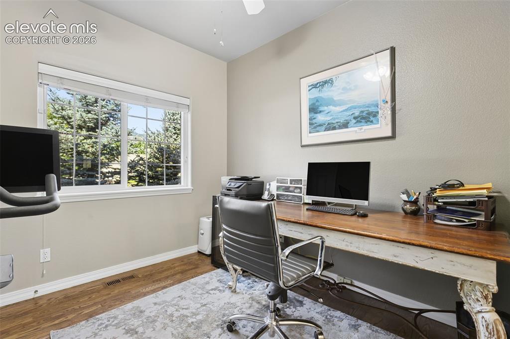 Image 26 of 50: Main level office has closet and french doors.
