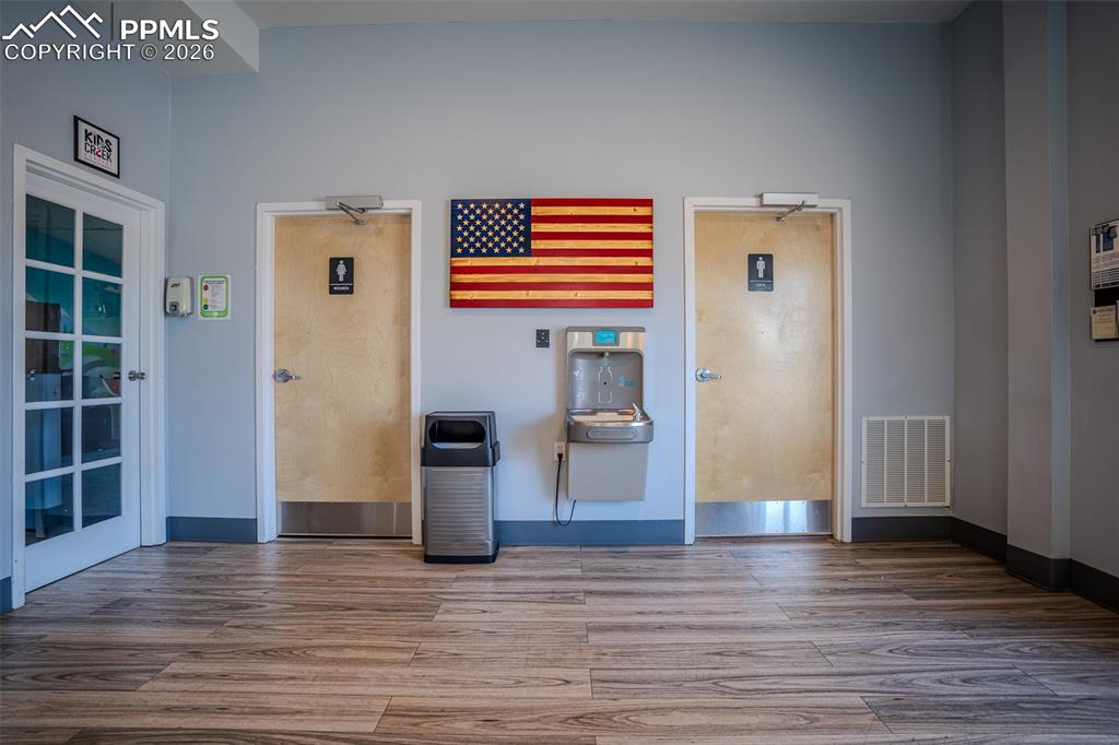 Image 16 of 26: Bathrooms located just right of entry