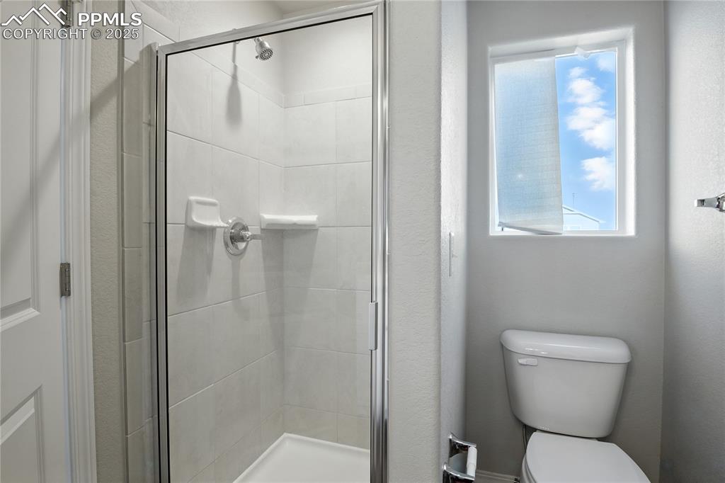 Image 23 of 28: Bathroom with a shower stall