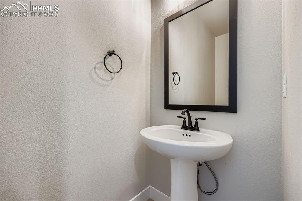 Image 13 of 28: Bathroom featuring a textured wall