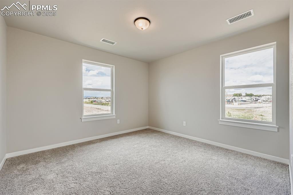 Image 21 of 28: Unfurnished room with carpet floors and baseboards