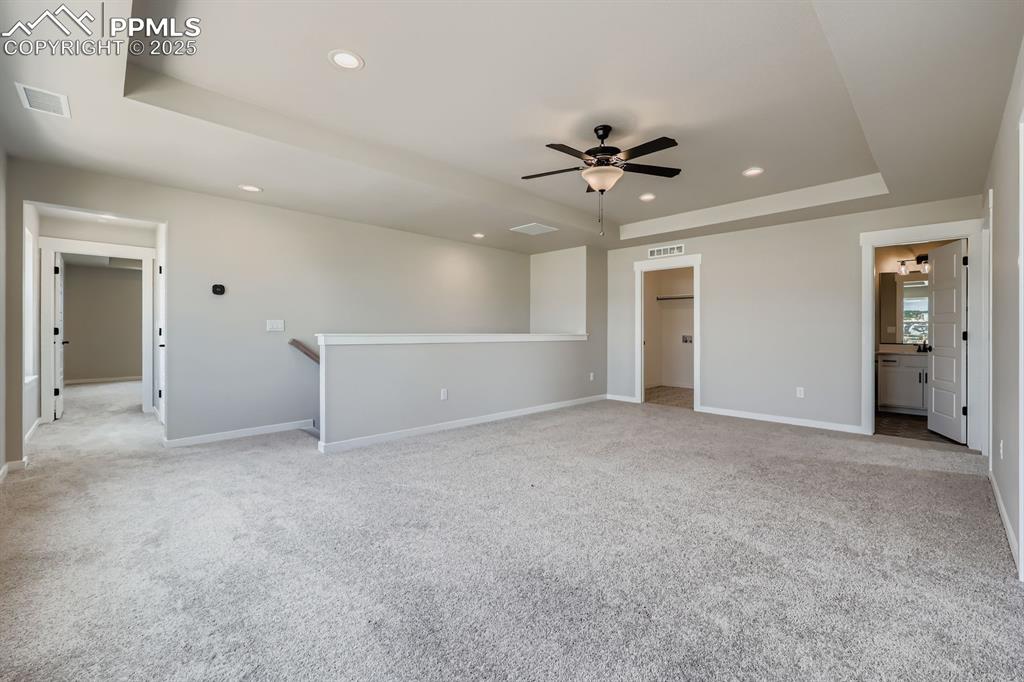 Image 23 of 28: Unfurnished room featuring a raised ceiling, recessed lighting, a ceiling f