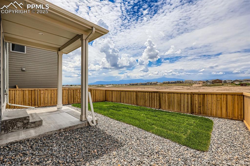 Image 26 of 28: Fenced backyard featuring a patio area and a mountain view