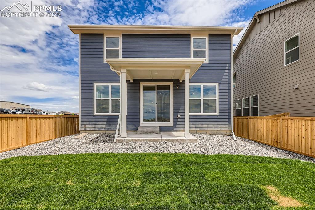 Image 28 of 28: Back of house featuring a fenced backyard and a patio
