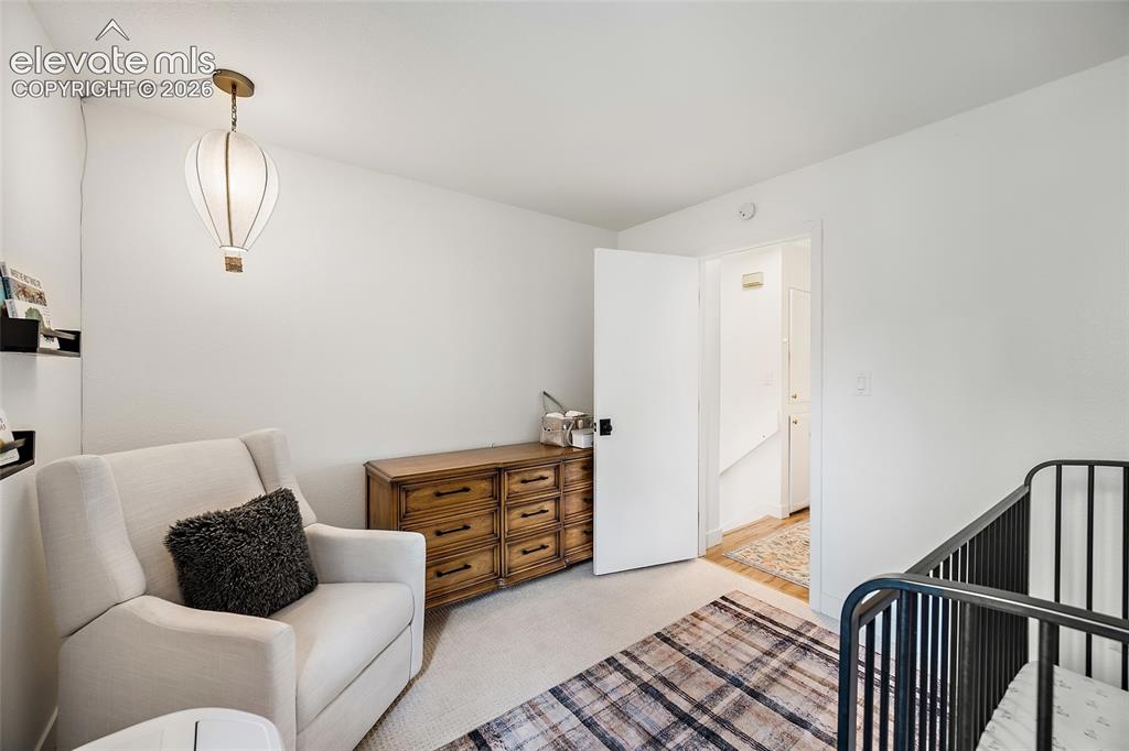 Image 30 of 50: Bright interior space featuring light-colored walls and carpeted flooring