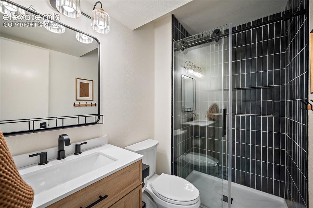 Image 35 of 50: Contemporary bathroom featuring a light wood-finish vanity with a white cou