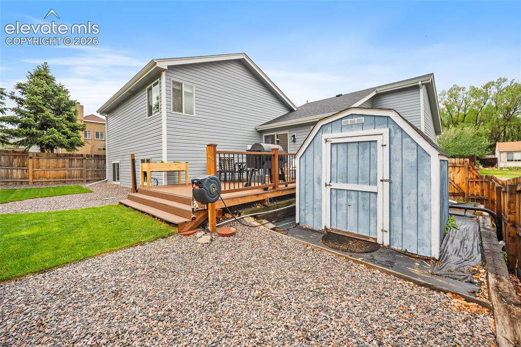 Image 45 of 50: Storage shed and more gardening beds behind