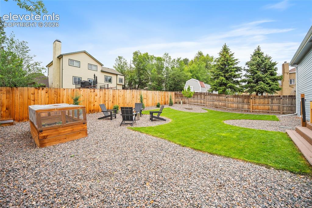Image 46 of 50: Garden beds and lots of yard space to host