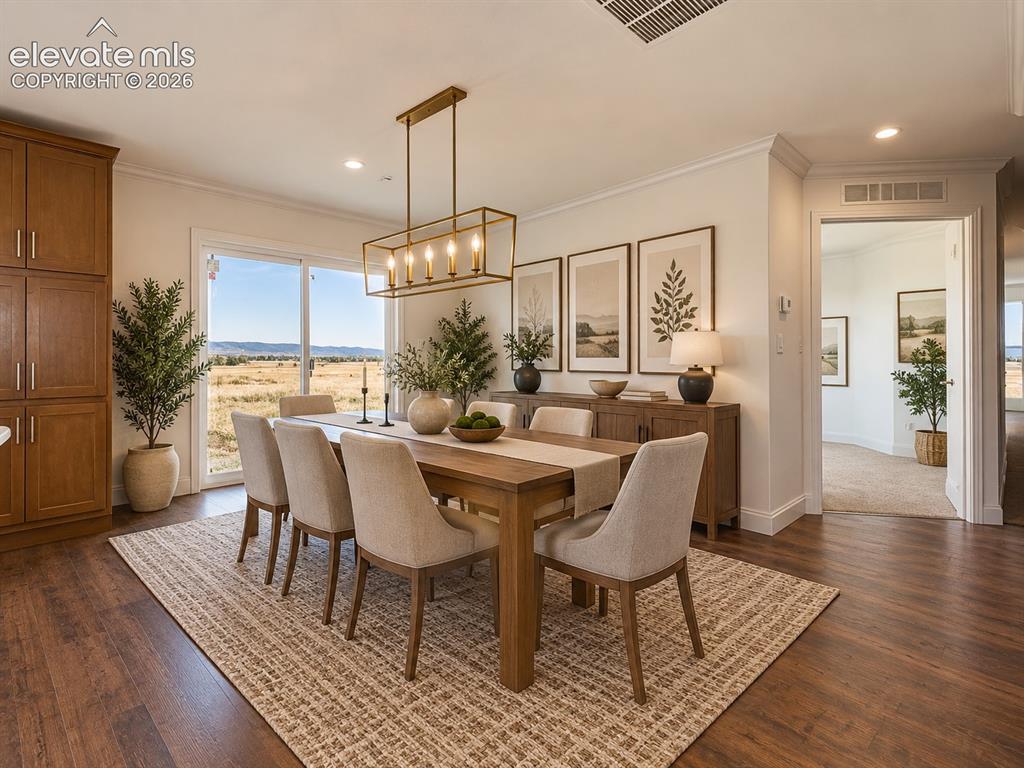 Image 10 of 34: Dining Area – Spacious dining area is positioned beside the kitchen and sli