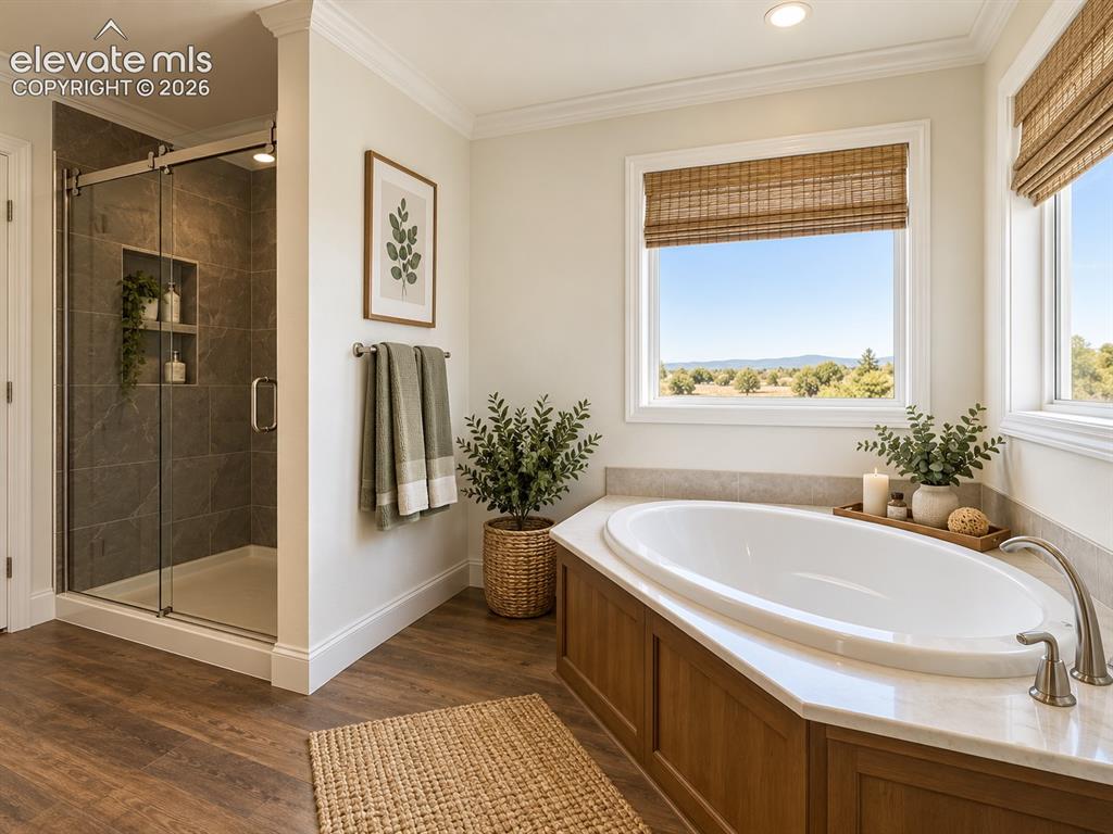 Image 16 of 34: Primary Bathroom – Bright primary bath features a soaking tub beneath large
