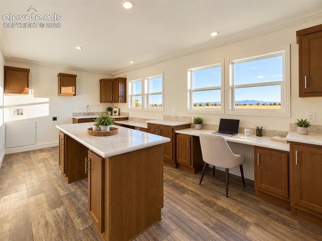 Image 27 of 34: Laundry / Multipurpose Space – Multiple windows bring natural light and exp
