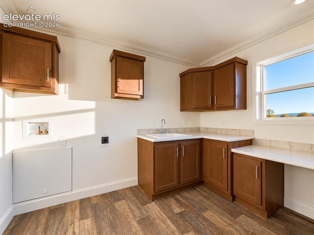 Image 28 of 34: Laundry Area – Dedicated laundry hookups are complemented by a utility sink