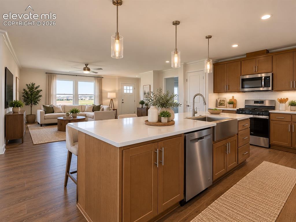 Image 8 of 34: Kitchen & Great Room – The large center island anchors the open kitchen, wi