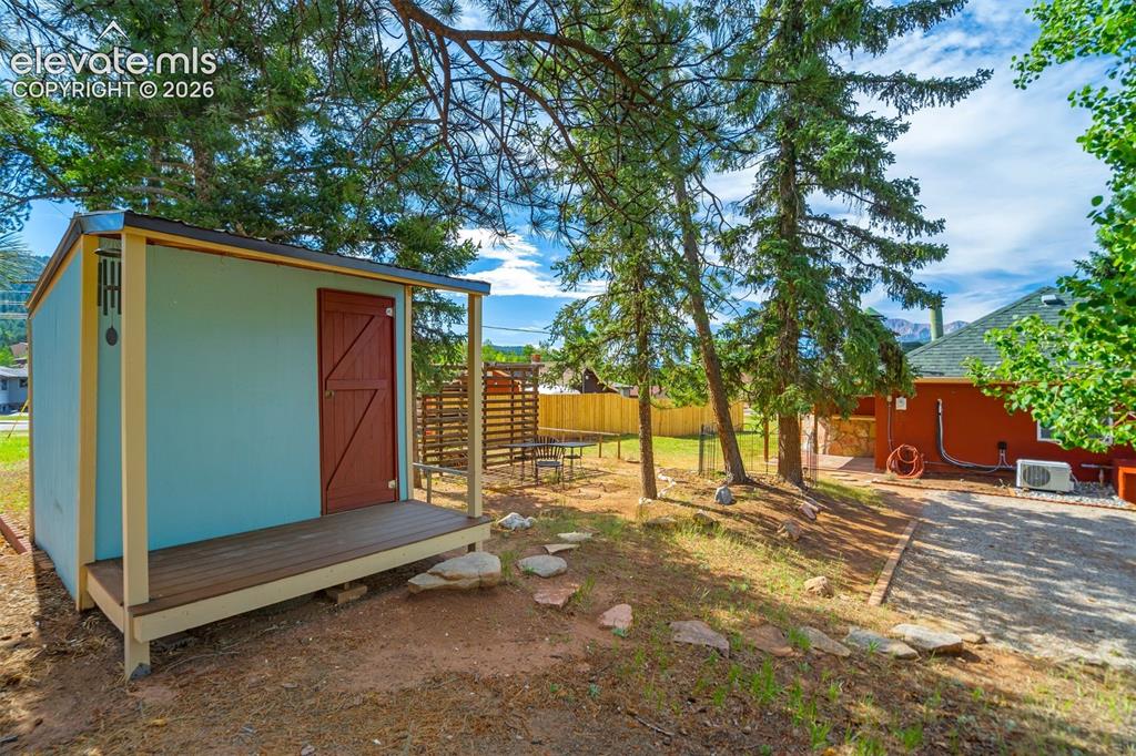 Image 23 of 37: storage shed with darling front porch