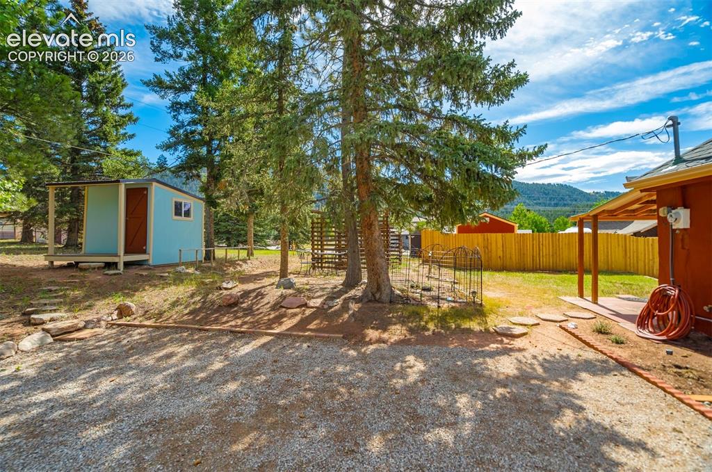 Image 25 of 37: Yard with patio area and storage shed