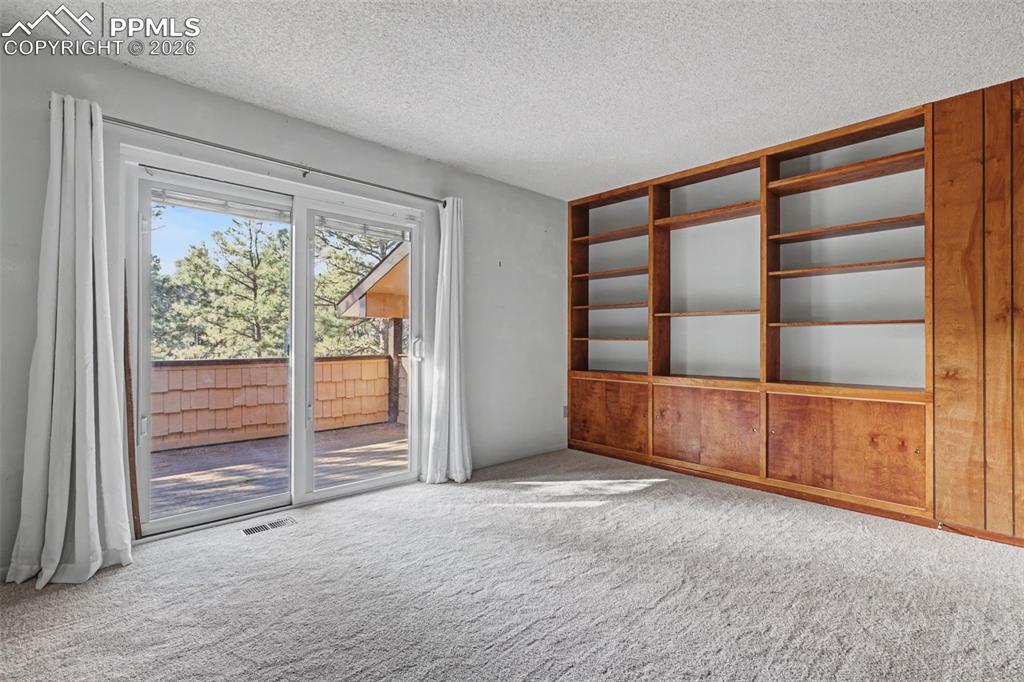 Image 21 of 38: Upper 2nd bedroom with Aspen paneling and built ins 