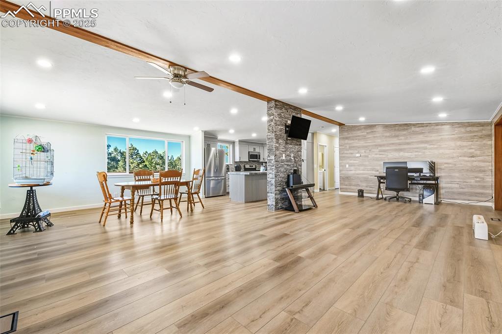 Image 8 of 46: Great Room view into kitchen and dining room