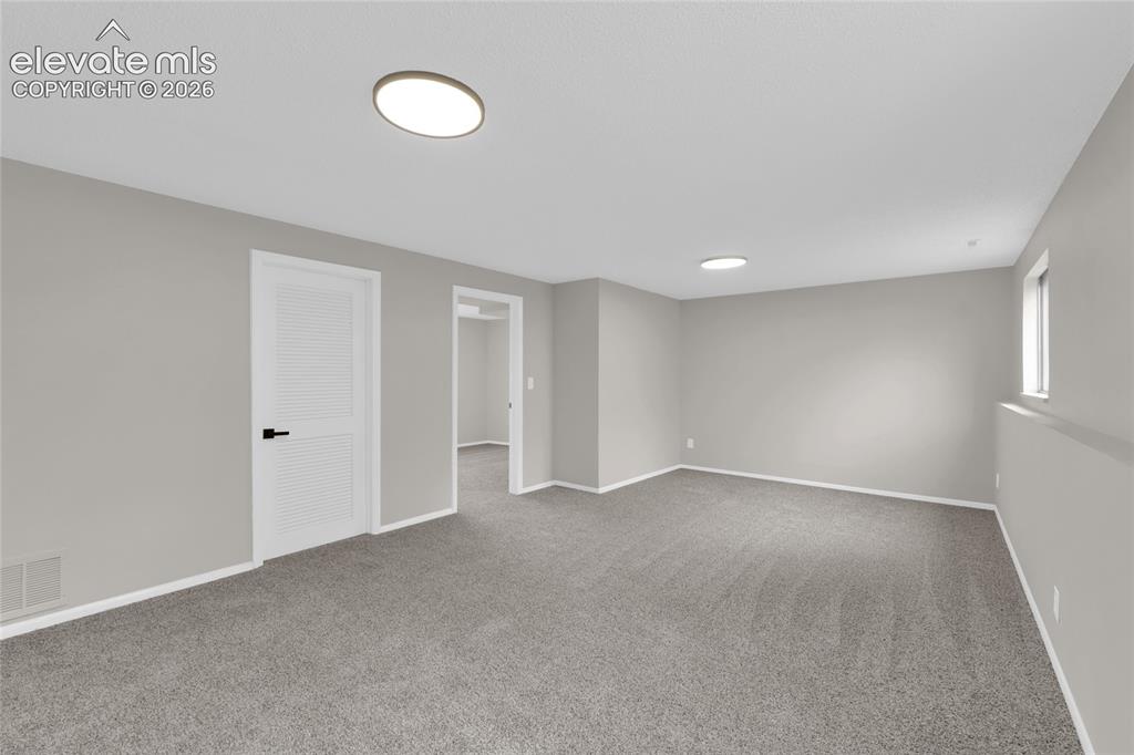 Image 13 of 29: Carpet flooring, recessed lighting, white baseboards, louvered door, and wi