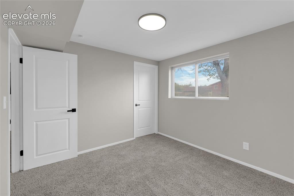 Image 16 of 29: Recessed lighting, light gray wall finish, white trim, light gray carpeting