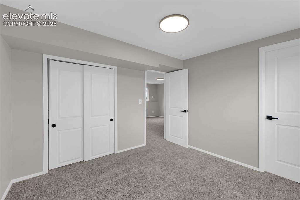 Image 17 of 29: Wall-to-wall carpeting with light gray walls, featuring white trim and whit