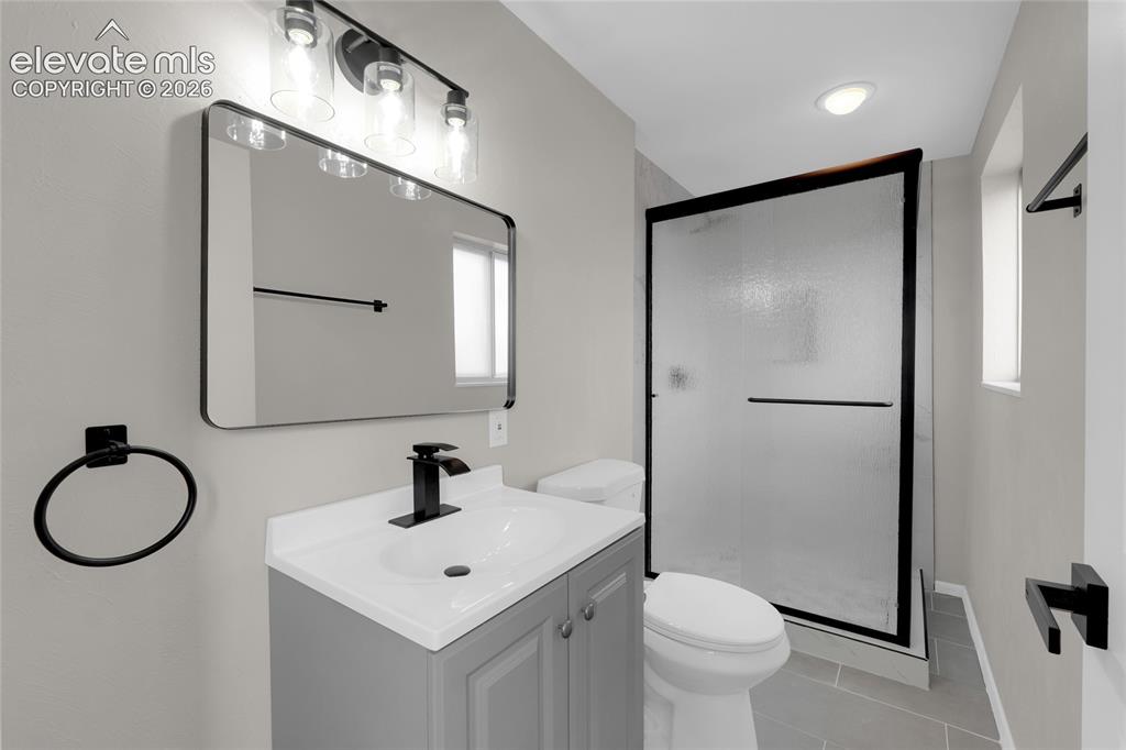 Image 19 of 29: Bathroom featuring a single vanity with an undermount sink, a shower enclos