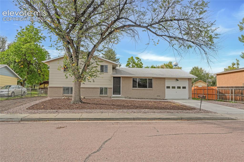 Image 2 of 29: Two-story residence featuring a front-facing garage with a segmented door, 