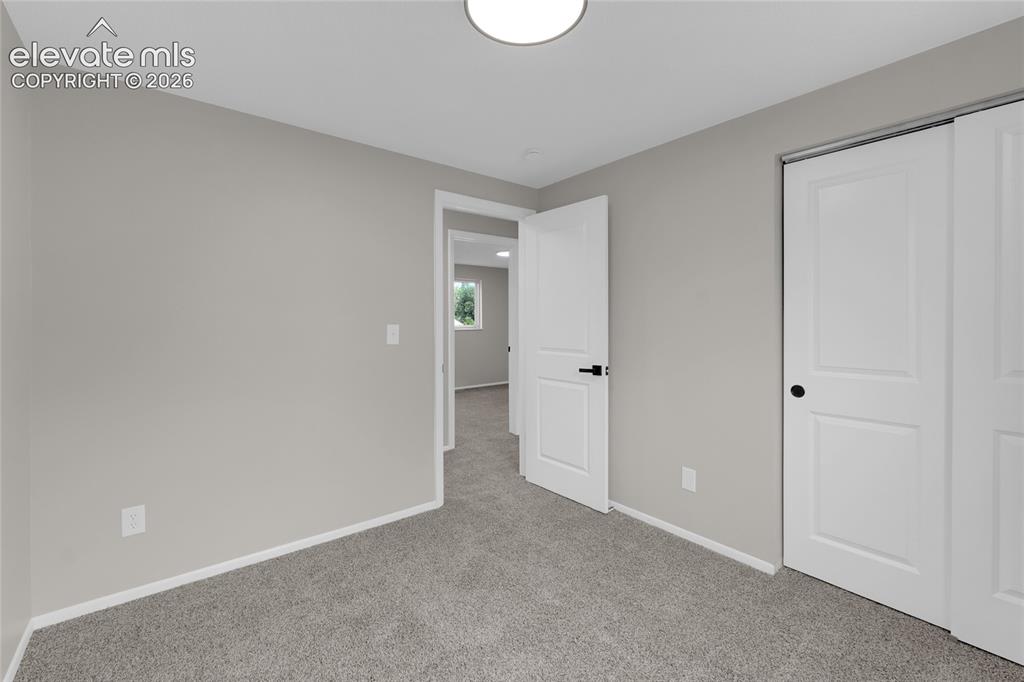 Image 24 of 29: Neutral-toned walls complement plush carpeting