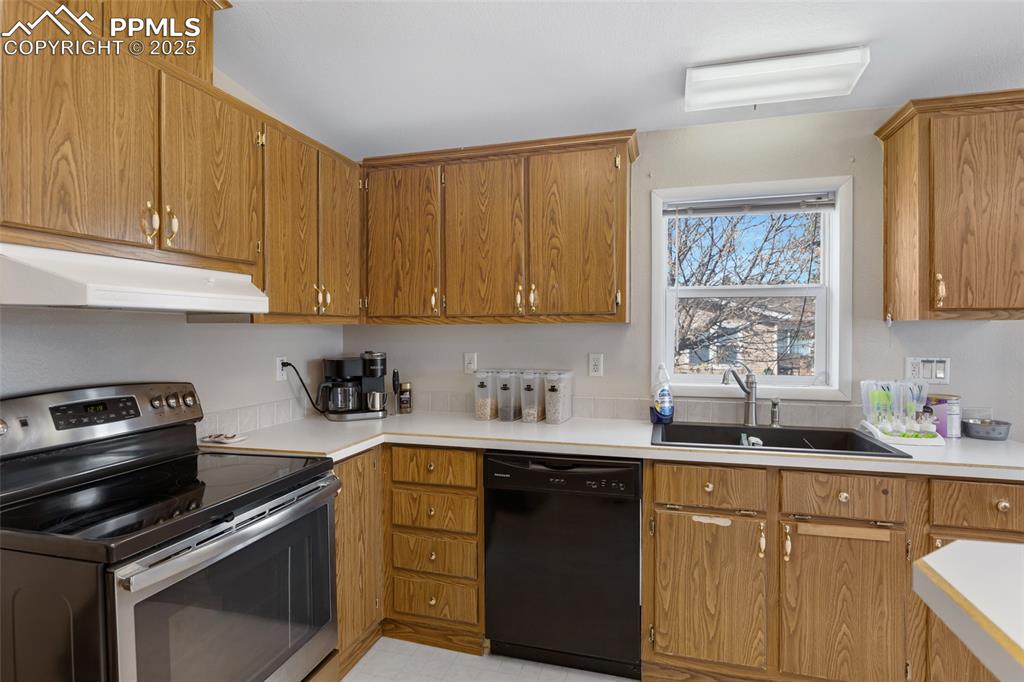 Image 11 of 24: Kitchen featuring light countertops, dishwasher, stainless steel range with