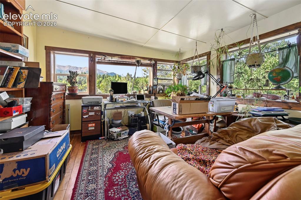 Image 18 of 29: Hardwood flooring throughout, multiple windows, natural wood window trim, b