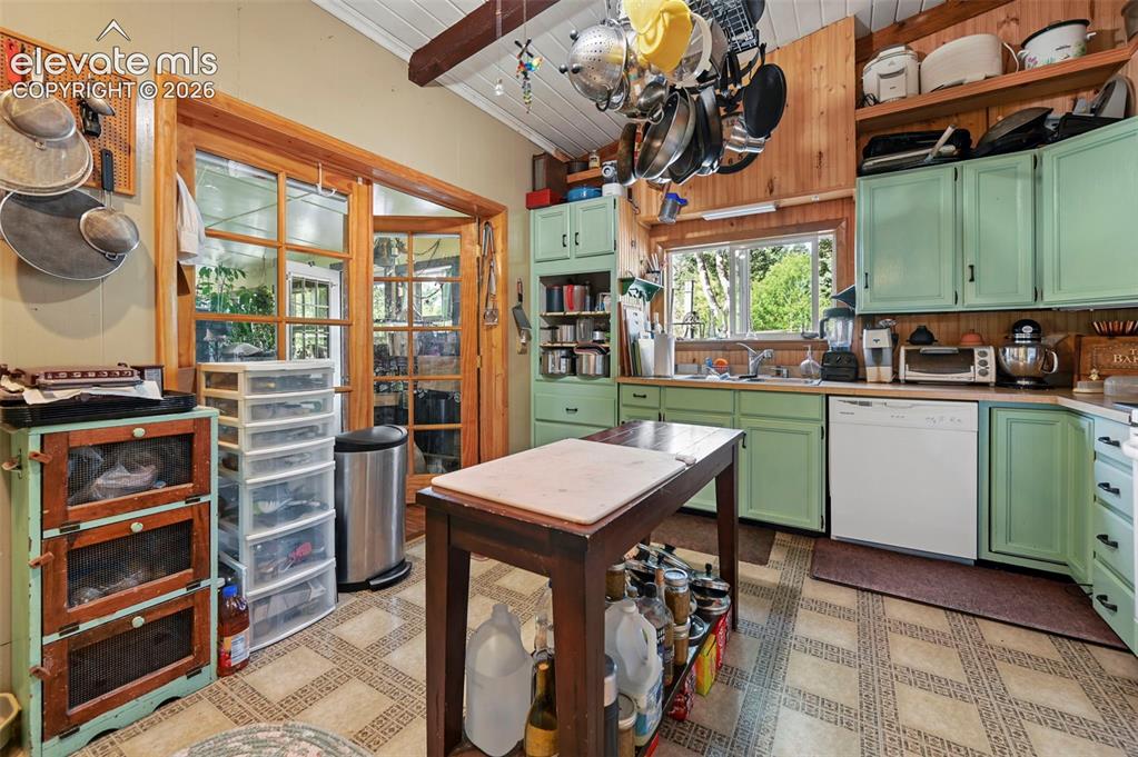 Image 6 of 29: Kitchen featuring wood-finish cabinetry, a single basin sink, a dishwasher,