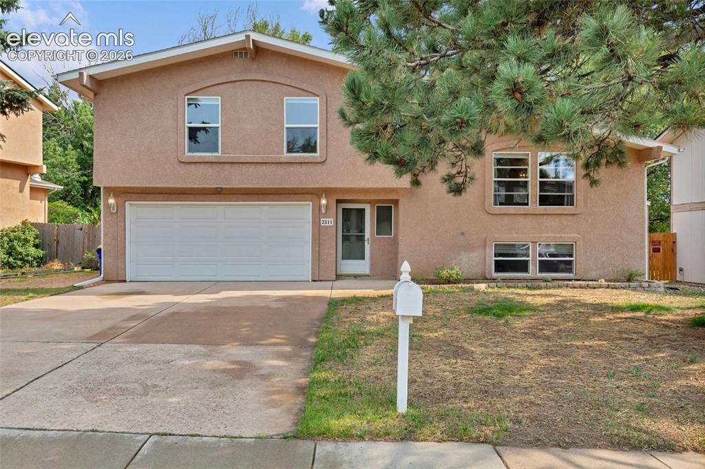 Caption: Stucco exterior with an attached two-car garage