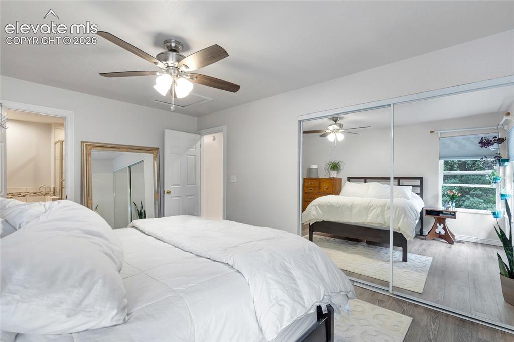 Image 22 of 44: Room featuring light gray walls, wood-finish flooring, a ceiling fan with i