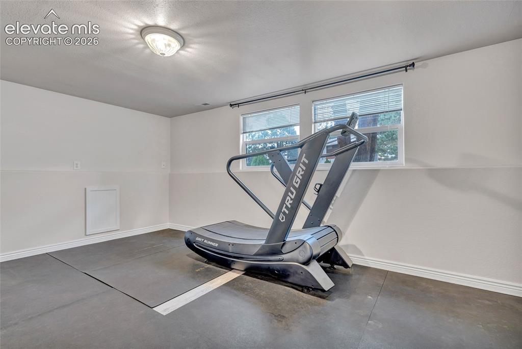 Image 25 of 44: Recreational room featuring a flush-mount ceiling light, two windows with b