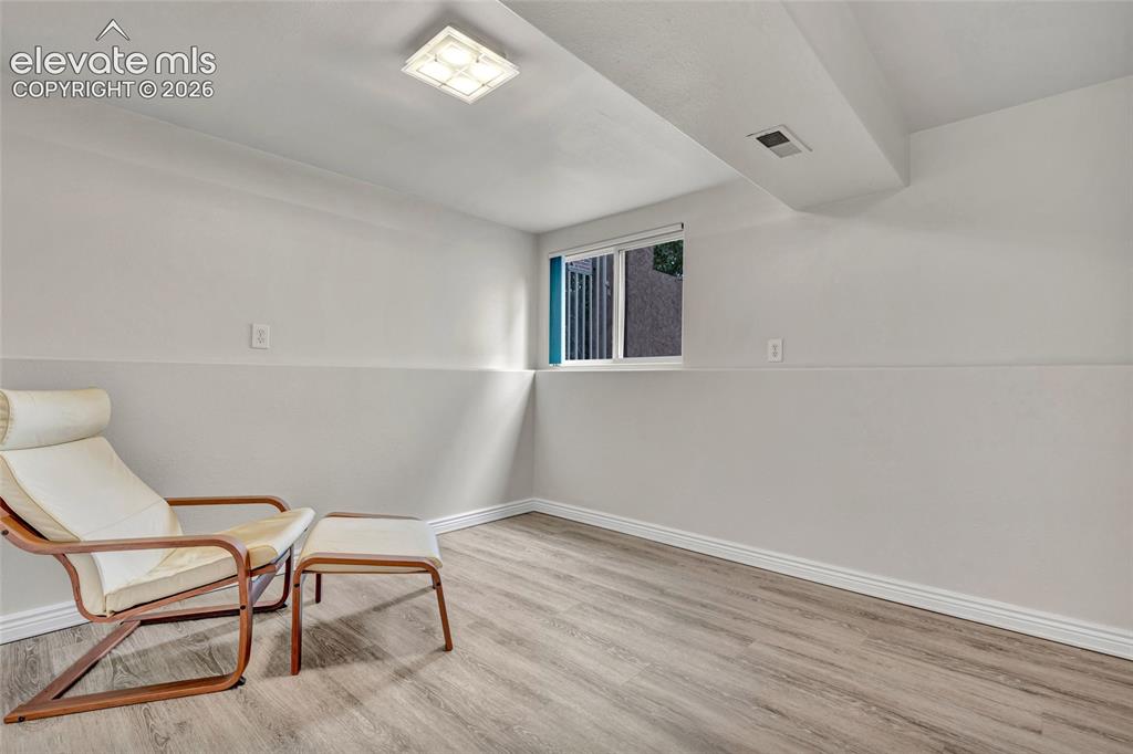 Image 28 of 44: Versatile lower-level room featuring light wood-finish flooring, neutral pa