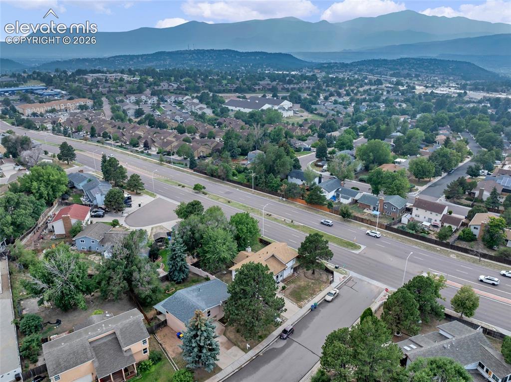 Image 38 of 44: Established residential area featuring mature trees and mountain backdrops