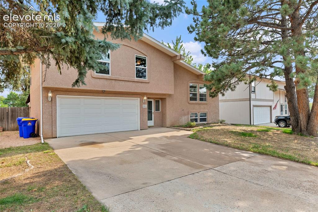 Image 4 of 44: Stucco exterior residence featuring a two-car garage, concrete driveway, an