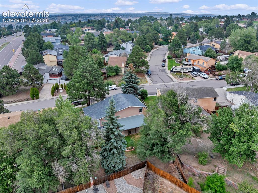 Image 41 of 44: Spacious residential property with a multi-level rear yard, featuring a ret