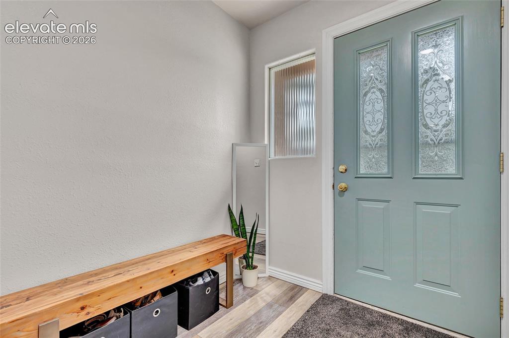 Image 5 of 44: Entryway featuring a paneled door with decorative glass inserts and a sidel