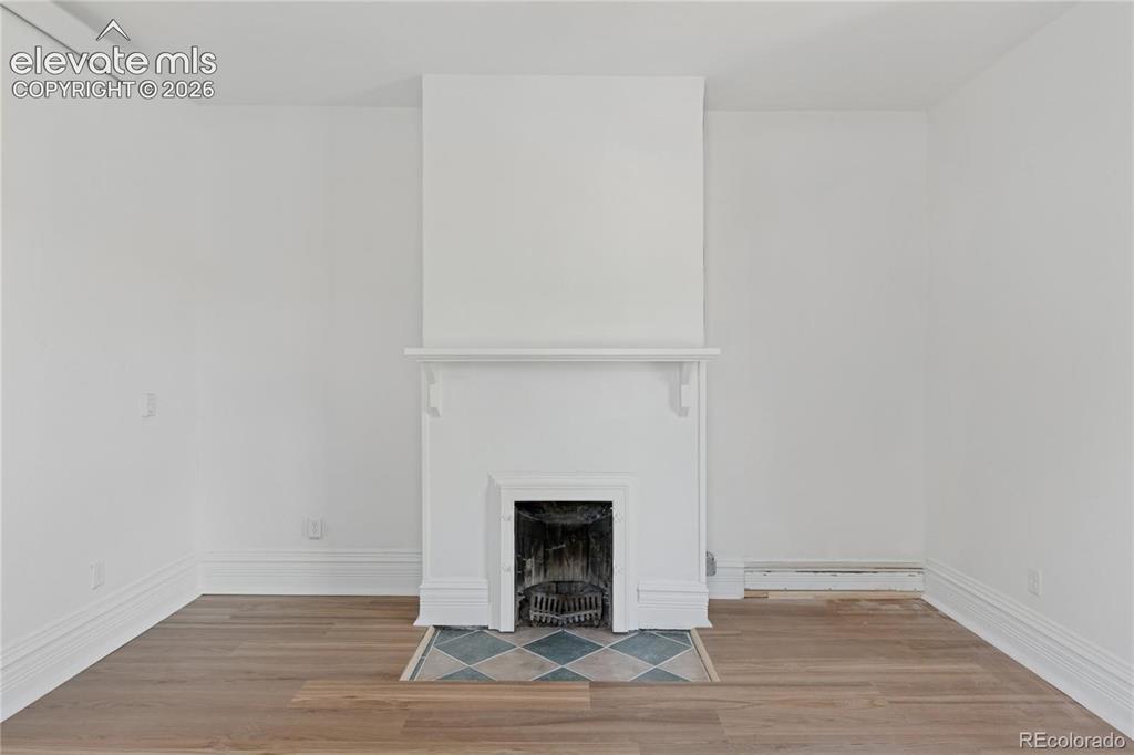 Image 11 of 49: Main-level flat primary
suite features a
fireplace