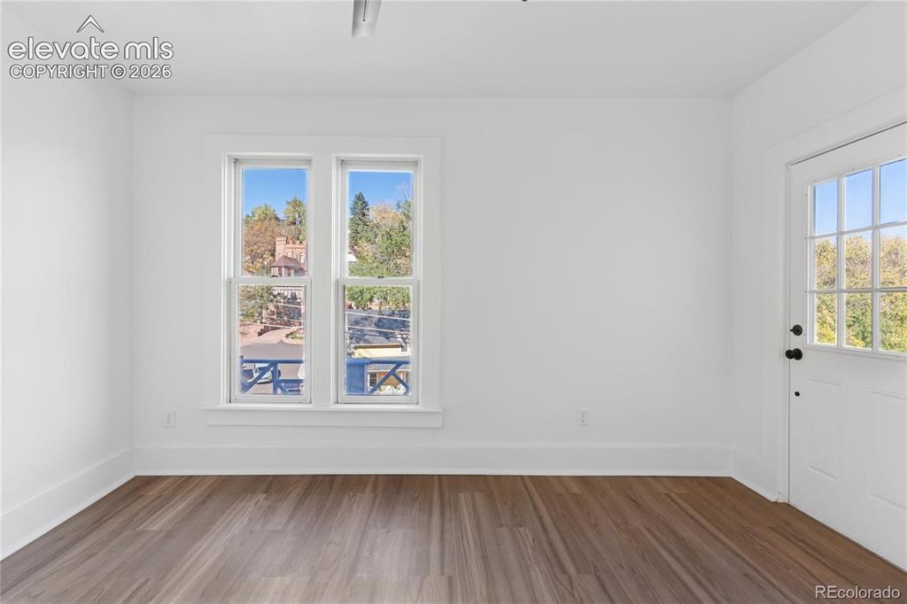 Image 29 of 49: 2nd-floor flat primary
bedroom, adjoining
shared bath, door to
balcony