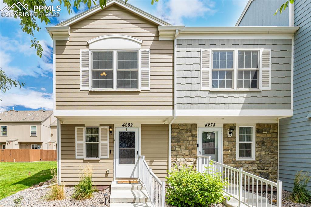 Caption: View of front of property featuring stone siding