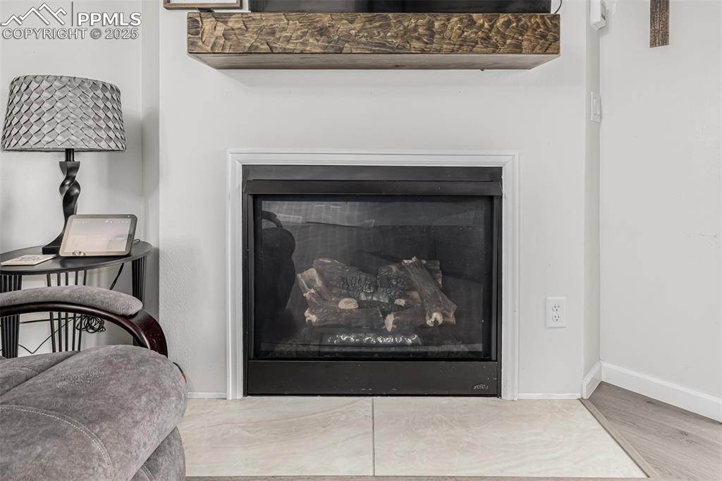 Image 17 of 47: Detailed view of a fireplace and wood finished floors